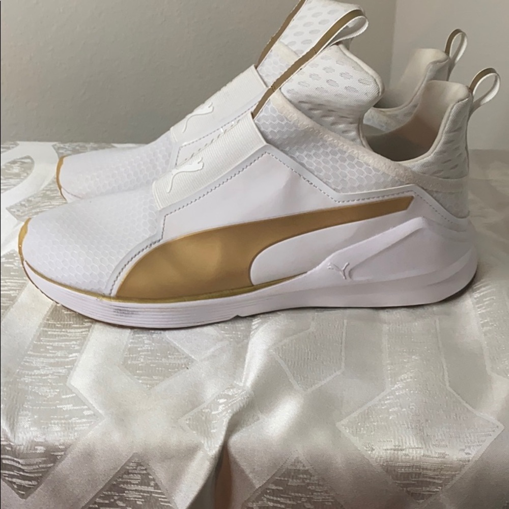 Woman’s white & gold Puma shoes